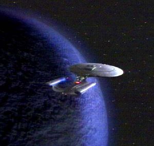 Enterprise in orbit above a planet.