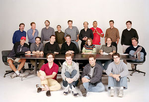 The Simpsons writing staff in season 13, including current show runner Al Jean (fourth from left in middle row) and previous show runners Mike Scully (first from left in back row), David Mirkin (sixth from left in back row), and Mike Reiss (fourth from left in back row).